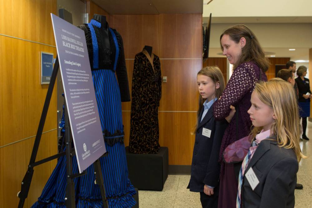 Some guests looking at the costumes on display.